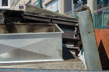 Dirty extraction fan parts from professional kitchen. Dusty and greasy old parts being thrown away and replaced.