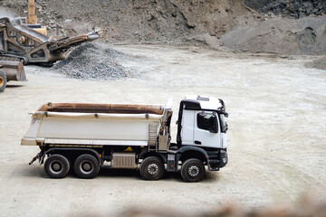 Industrial machinery details - dumper trucks waiting for loading at quarry and construction site. Industry details © aboutmomentsimages