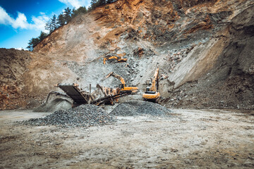 Iron mine, quarry, iron ore mining details. Industrial machinery working with rock breaker and crusher, dumper trucks and loaders