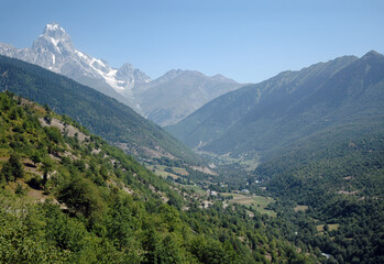 Fototapeta na wymiar Summit of Ushba Mount and Enguri River Valley. Svaneti Region, Georgia, Caucasus.