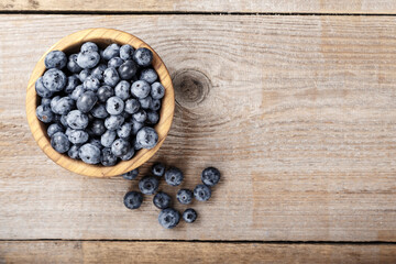 Freshly picked blueberries in wooden bowl. Blueberry antioxidant.