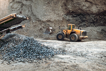 Industrial machinery on ore quarry site, heavy duty excavator moving gravel and rocks © aboutmomentsimages
