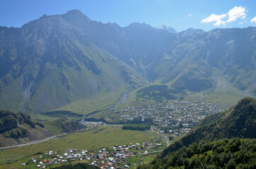 Fototapeta na wymiar View at Gergeti village and Stepantsminda village. Georgia, Caucasus.