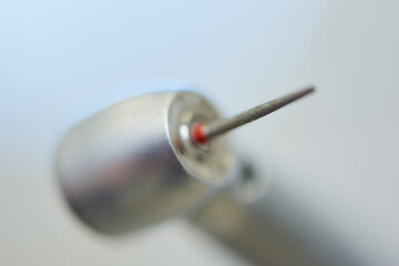 A close photo of a dental diamond bur in the turbine stainless handpiece.