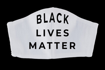 Black Lives Matter on face mask. White protective mask on black background. Concept of protest against racism and violence. Isolated