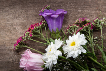 Wild flowers bouquet on wooden background