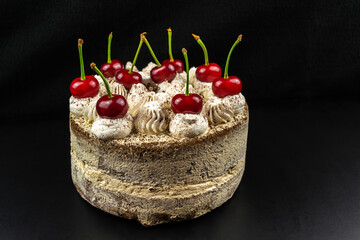 Tiramisu cake decorated with cherries,