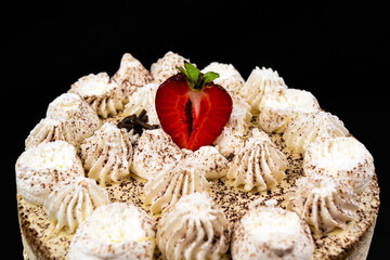 Tiramisu cake decorated with a slice of strawberries
