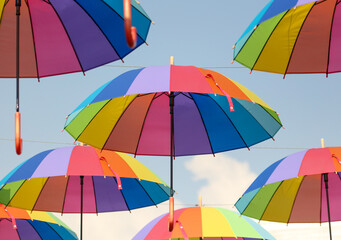 Umbrellas in the color of the rainbow against the  sky.