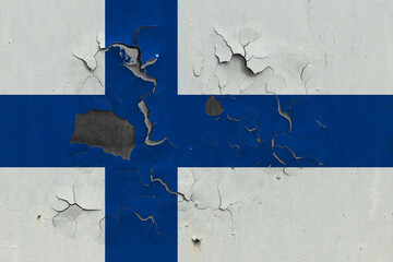 Finland flag close up old, damaged and dirty on wall peeling off paint to see inside surface....