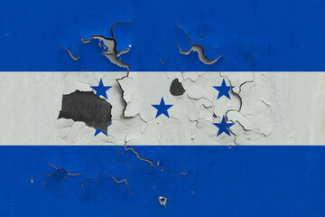 Honduras flag close up old, damaged and dirty on wall peeling off paint to see inside surface. Vintage National Concept.