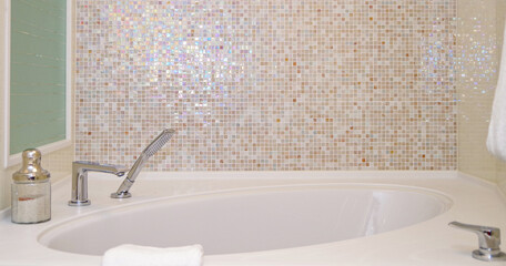 Clean and modern design bathroom with shower, bath tub, towels and mirror and mosaic tiles in cabin...