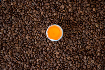 coffee beans and broken egg. eggs and coffee for breakfast in the morning.