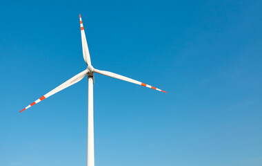 Wind turbine against the blue sky.