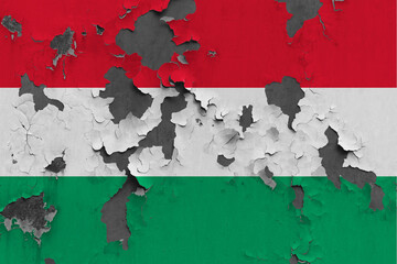 Hungary flag close up painted, damaged and dirty on wall peeling off paint to see concrete surface. Vintage National Concept.