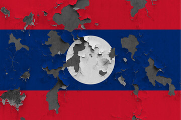 Laos flag close up painted, damaged and dirty on wall peeling off paint to see concrete surface. Vintage National Concept.