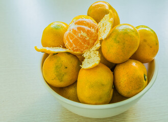 Imperfect tangerines in a white bowl