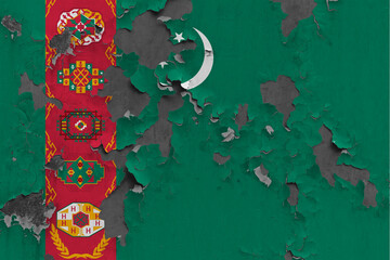 Turkmenistan flag close up painted, damaged and dirty on wall peeling off paint to see concrete surface. Vintage National Concept.
