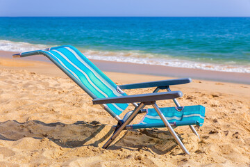 One blue beach chair at coast with sea