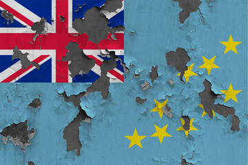 Tuvalu flag close up painted, damaged and dirty on wall peeling off paint to see concrete surface....