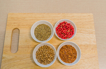 Spices in white bowl on cutting board