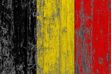 Belgium flag on grunge scratched wooden surface. National vintage background. Old wooden table scratched flag surface.