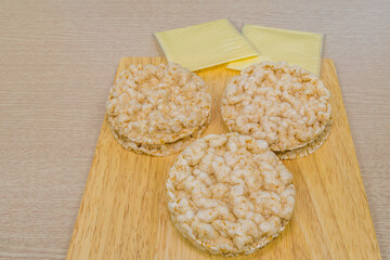 Rice cakes and cheese on cutting board
