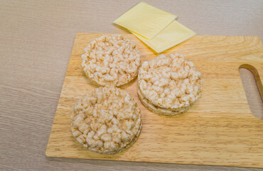 Rice cakes and cheese on cutting board