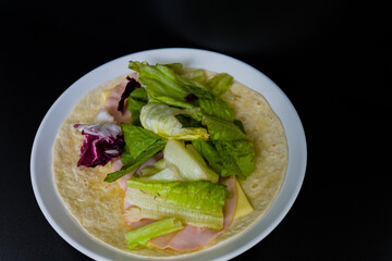 Ham, mozzarella cheese and lettuce  on flour tortilla