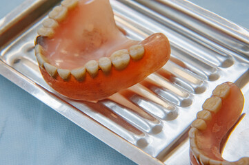 Close-up an acrylic denture prosthesis of the upper and lower jaws of a man