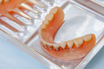 Close-up an acrylic denture prosthesis of the upper and lower jaws of a man