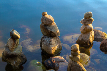 Zen stones on beach lake for meditation.