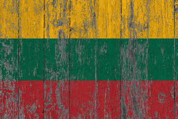 Lithuania flag on grunge scratched wooden surface. National vintage background. Old wooden table scratched flag surface.