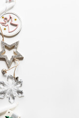 White, silver and golden ornaments, candles, Christmas wreath, gift box frame background. Festive winter concept.