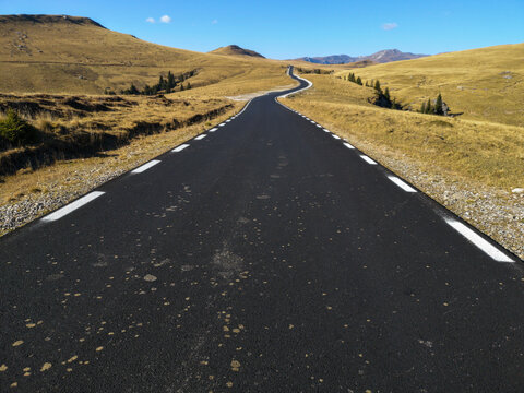 Mountain road. Landscape with rocks, sunny sky and beautiful asphalt road  in summer.  Travel background. Highway in mountains. Transportation 