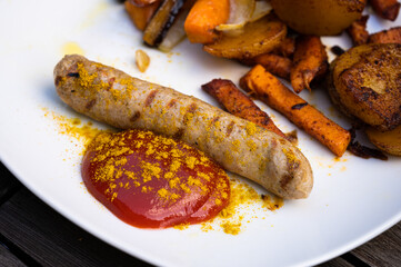 vegan curry sausage with potato and sweet potato split, ketchup with curry powder