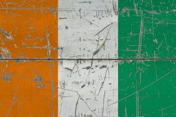 Cote D'Ivoire flag painted on cracked dirty surface. National pattern on vintage style surface. Scratched and weathered concept.