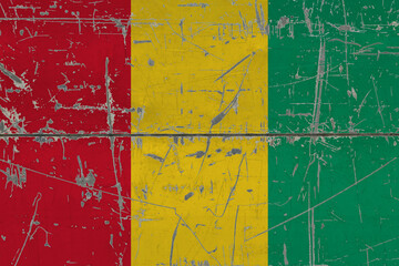 Guinea Bissau flag painted on cracked dirty surface. National pattern on vintage style surface. Scratched and weathered concept.