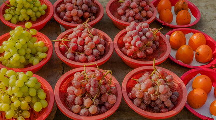 Bowls of green and red grapes
