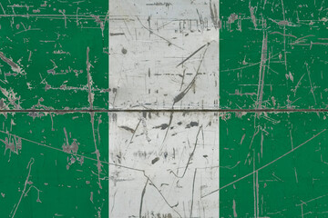 Nigeria flag painted on cracked dirty surface. National pattern on vintage style surface. Scratched and weathered concept.