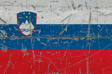 Slovenia flag painted on cracked dirty surface. National pattern on vintage style surface. Scratched and weathered concept.