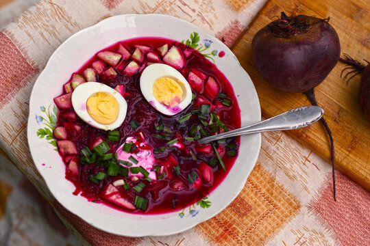 beetroot cold soup with cucumbers, boiled egg, green onion, garlic and sour cream