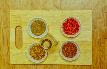 Spices in white bowl on cutting board