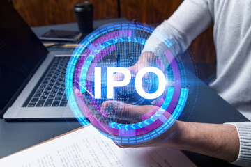 Man using phone. Hands typing smartphone. Double exposure with ipo hologram. Close up. Financial...