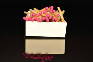 Matches made of wood, close-up, on a black background.