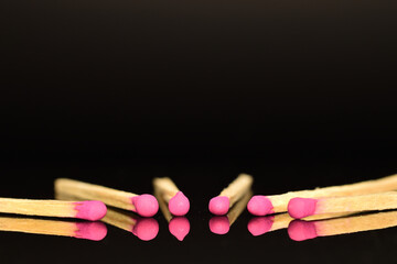 Matches made of wood, close-up, on a black background.