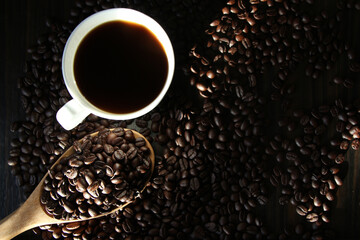 Coffee cup with beans on black table