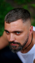 Obraz premium Close up portrait of bearded man posing confidently and looking haughtily