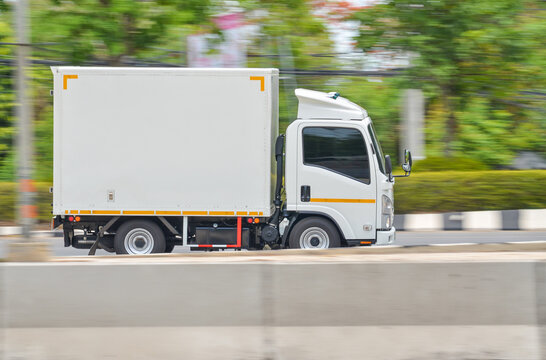 Motion image of a small white truck for road running transportation