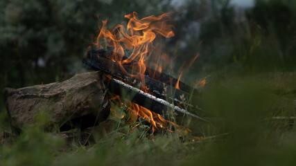 Kindling a fire of wood for cooking barbecue in nature. High quality photo